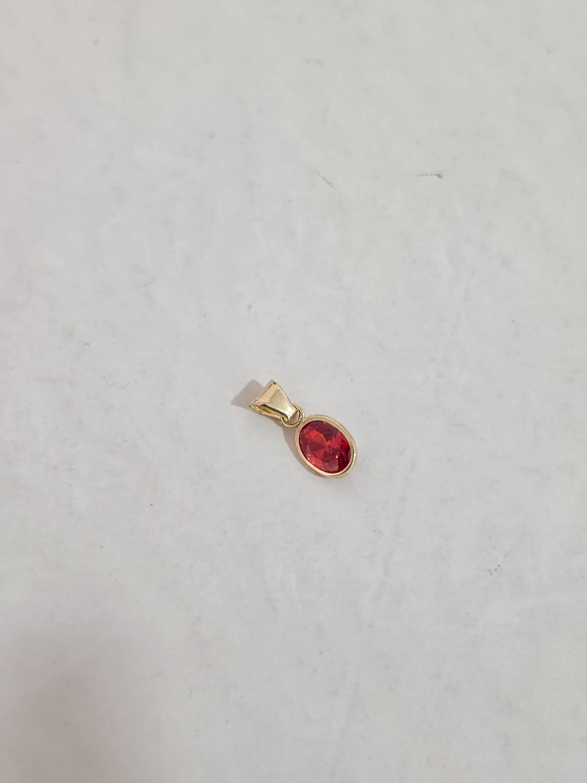 Dije corte oval con zirconia naranja oro 10k