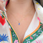Dije corte esmeralda con zirconia azul oro 10k