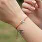 Pulsera de hilo rojo con ojito turco madre perla BIMETAL