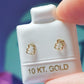 Par o pieza de Broquel osito silueta oro de 10k